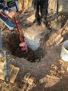 Contractors digging and inspecting for residential foundation repair