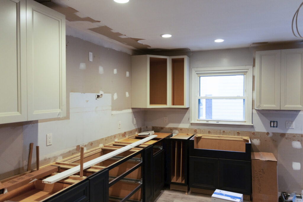 Kitchen cabinets being installed during a full kitchen remodel project