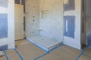 Bathroom renovation contractor installing custom walk-in shower