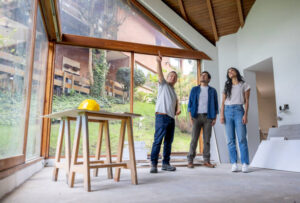 Home building contractor guiding clients through new home interior